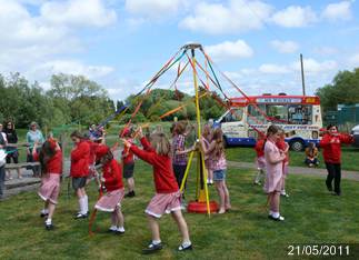 School children dance around the Maypole School children dance around the Maypole